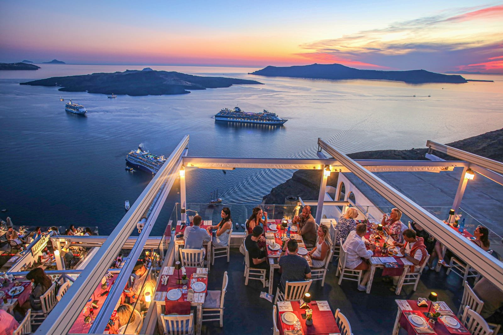 Lithos Restaurant, Fira, Santorini — rooftop terrace over the caldera at sunset