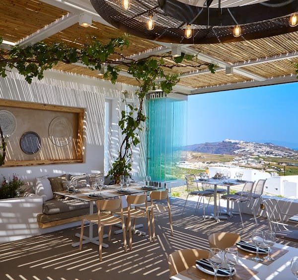 Pyrgos Restaurant, Pyrgos, Santorini — terrace tables under the pergola with views over the village